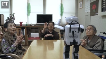 Elderly Japanese dancing and singing with a robot.